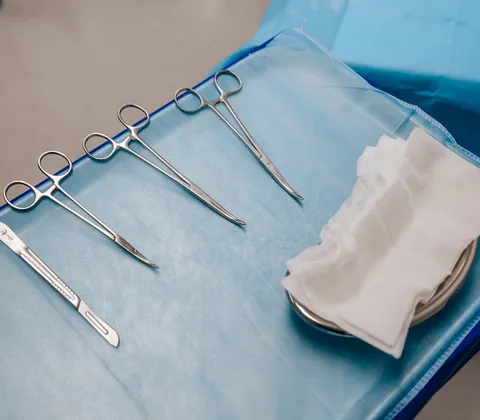 Sterile podiatry instruments laid out on a sterile drape, ready for a home visit appointment